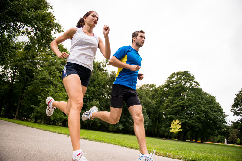 Back pain, injury and woman outdoor during exercise, training or running  accident. Fitness, spine problem and female athlete with arthritis,  fibromyalgia or emergency during body workout at park. Stock Photo